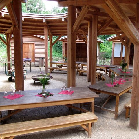 Vorbereitete Tische, Hütten und Feuerstelle im Rundling